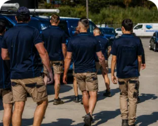 Plumbers walking to their service vans on a Mortlake job